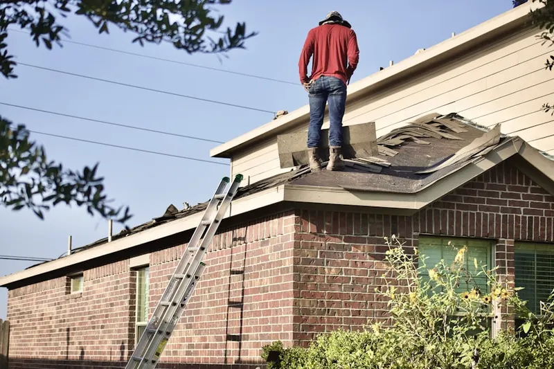 Professional roofer working on a residential roof in Deming